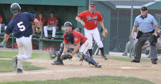 Pat Schultz tags out a St. Peter baserunner by a country mile, as Shane Hofmann looks on